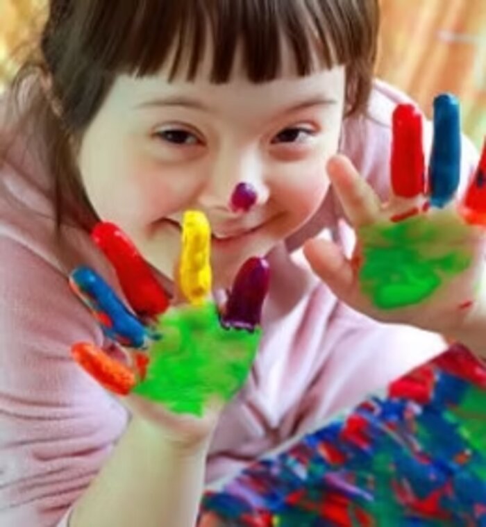Smiling girl with paint on her hands